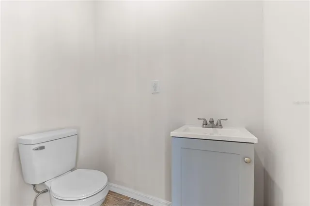 a bathroom with a sink toilet and a mirror