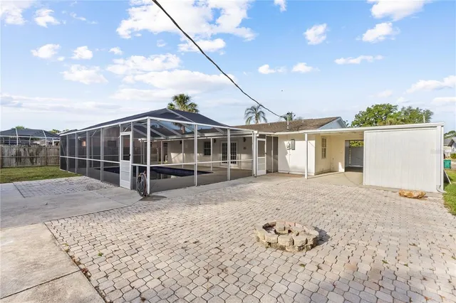 a view of a house with a backyard