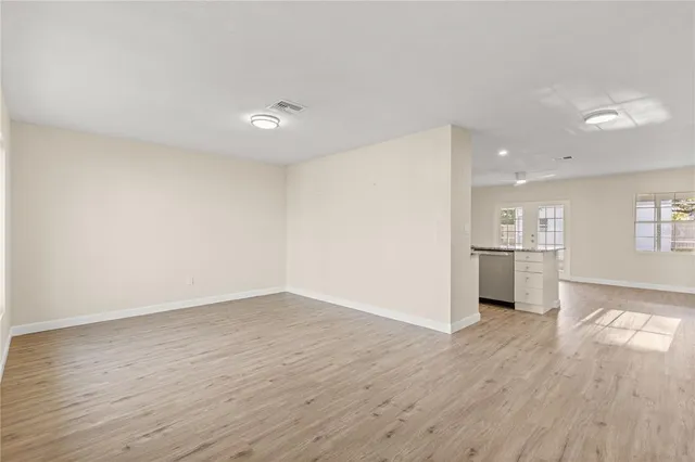 a view of a kitchen with wooden floor and a kitchen