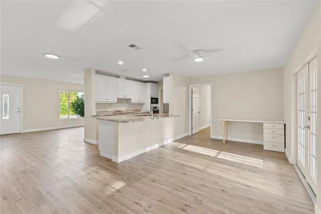 a view of kitchen with wooden floor and electronic appliances