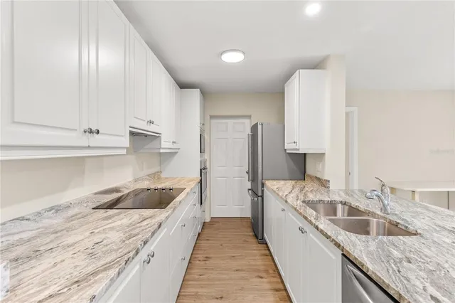 a kitchen with a sink stove and refrigerator