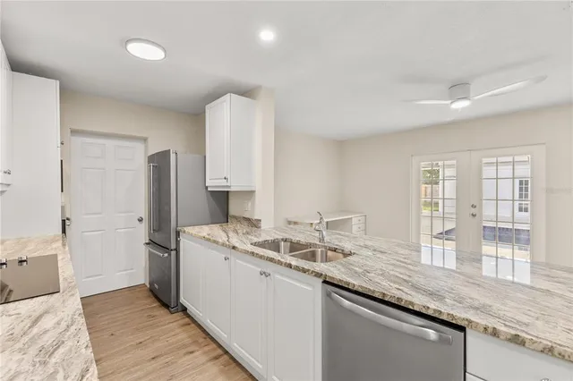 a kitchen with granite countertop a sink and a wooden cabinets