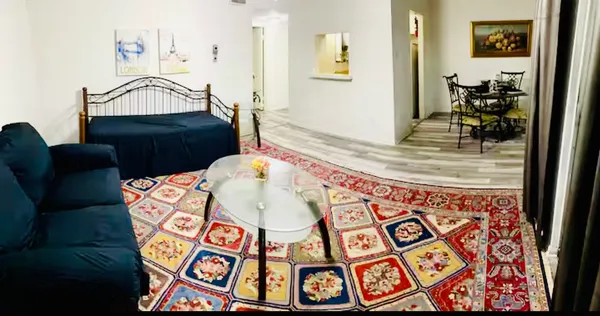 a view of a bedroom with furniture and wooden floor