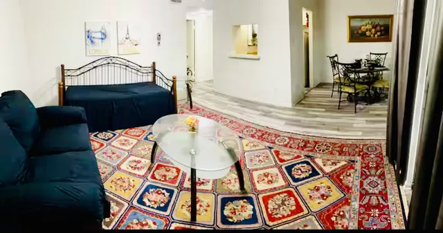a view of a bedroom with furniture and wooden floor