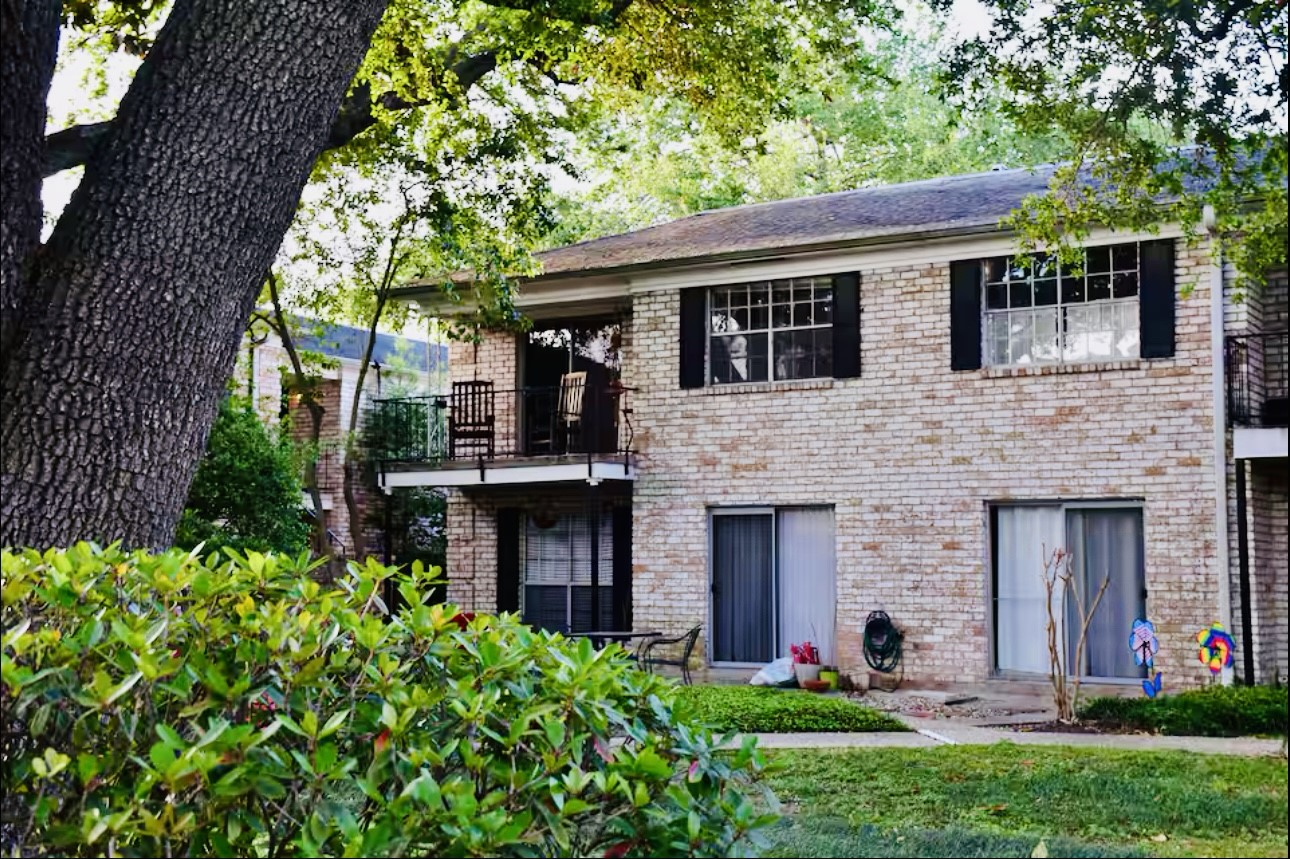 7900 Westheimer Road, Unit 220 Houston, TX 77063 - Photo 7 of 15 a front view of a house with a garden and plants