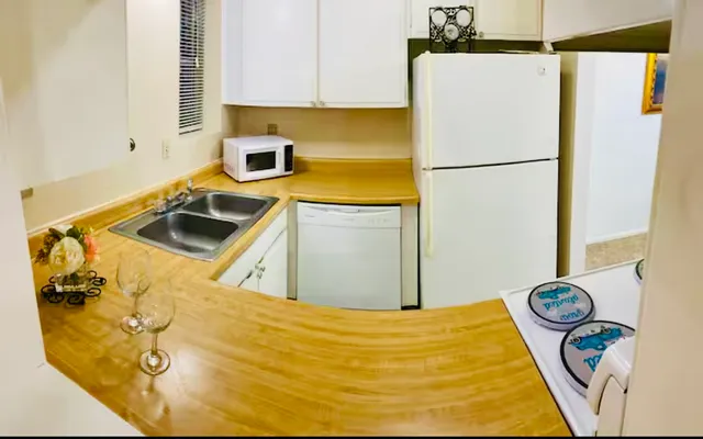 a kitchen with a refrigerator and a stove