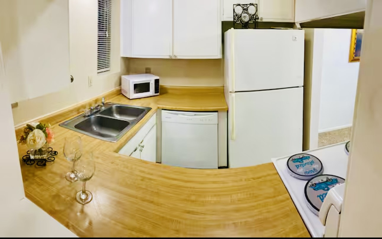 7900 Westheimer Road, Unit 220 Houston, TX 77063 - Photo 10 of 15 a kitchen with a refrigerator and a stove