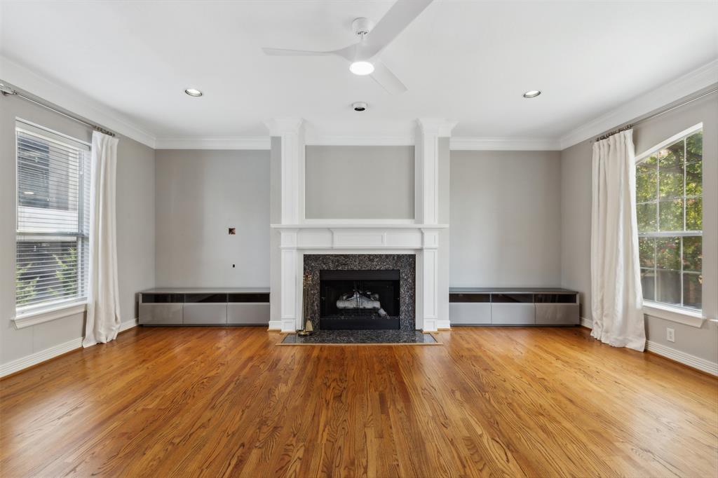 2704 Welborn Street, Unit H Dallas, TX 75219 - Photo 11 of 31 wooden floor fireplace and windows in an empty room