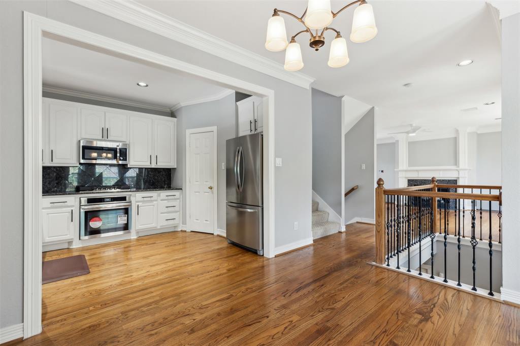 2704 Welborn Street, Unit H Dallas, TX 75219 - Photo 18 of 31 a kitchen with stainless steel appliances a refrigerator and a stove top oven