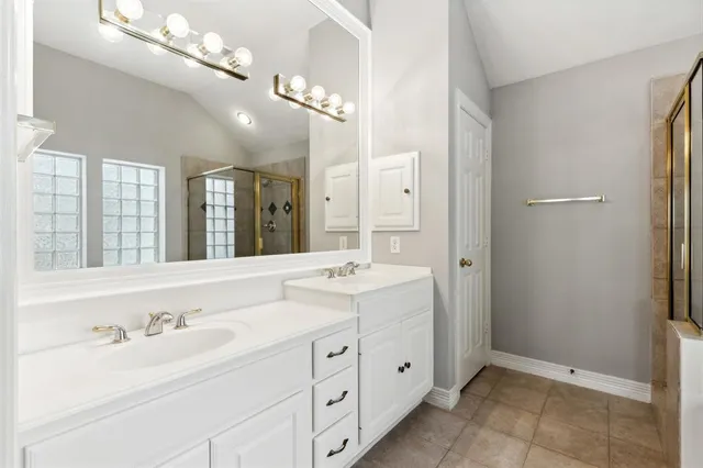 a bathroom with a double vanity sink mirror and double