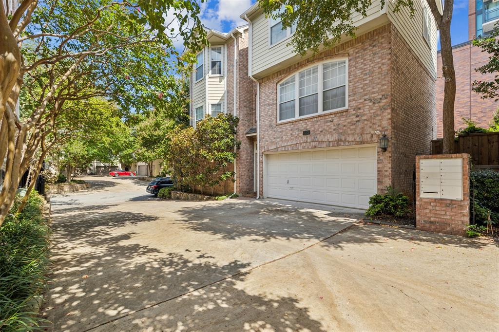 2704 Welborn Street, Unit H Dallas, TX 75219 - Photo 3 of 31 a front view of a house with a yard and garage