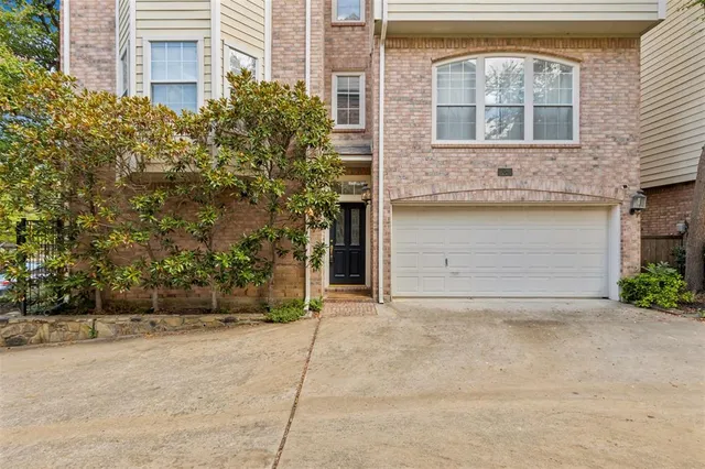 front view of a brick house with a yard
