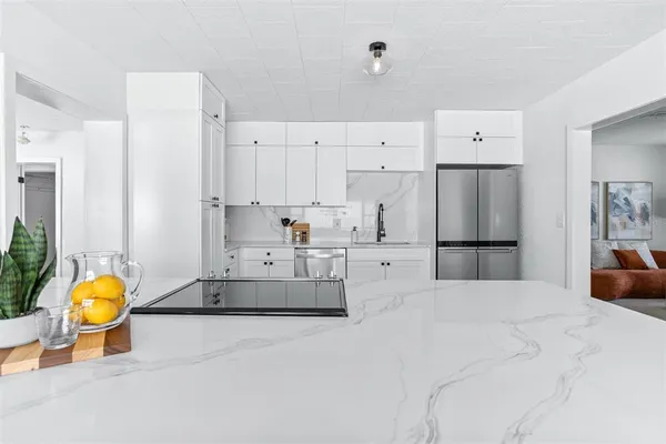 a large white bed in a white room