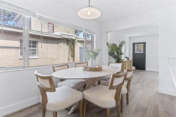 a view of a dining room with furniture and wooden floor