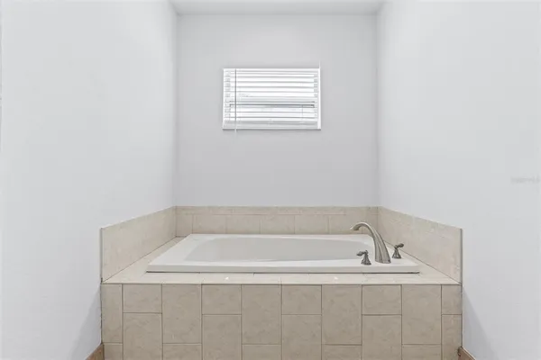 a white bath tub sitting in a bathroom