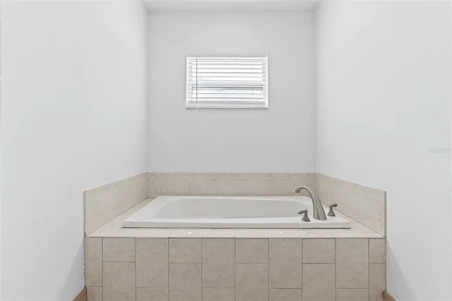 a white bath tub sitting in a bathroom