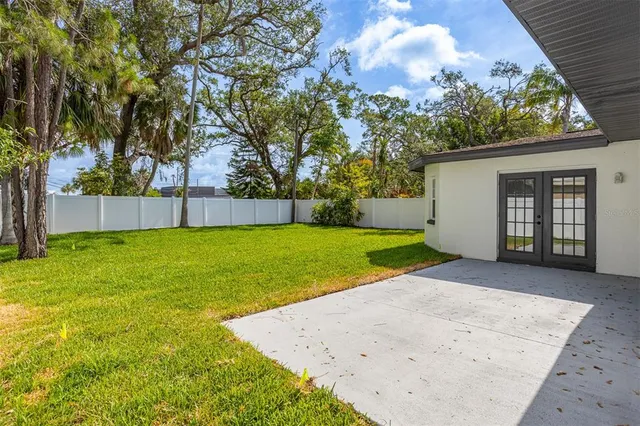 a view of a backyard with a garden and trees