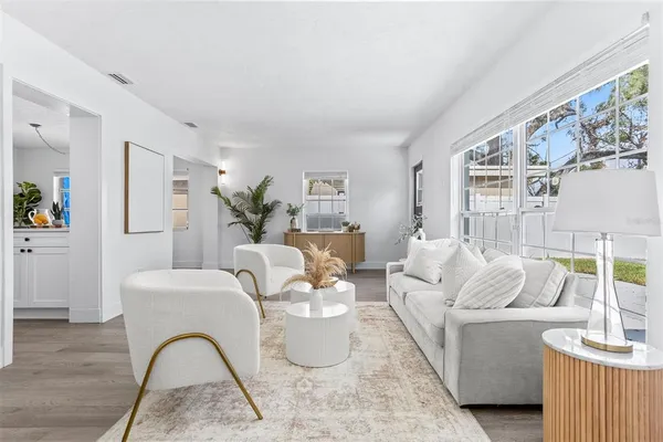 a living room with furniture and wooden floor