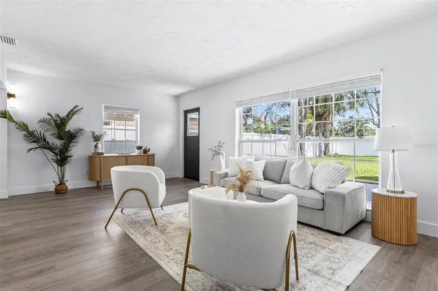 a living room with furniture and a large window