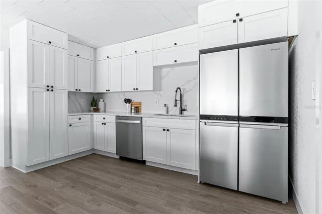 a kitchen with cabinets and white stainless steel appliances