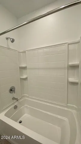 a bathroom with a shower and a bath tub