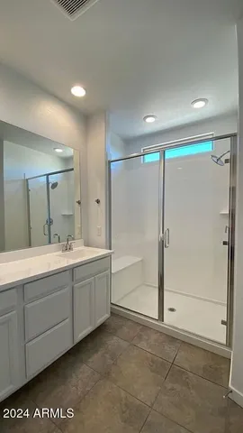 a bathroom with a tub shower and sink