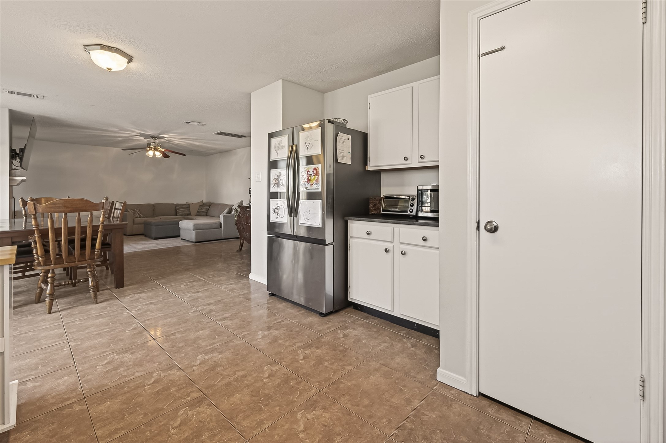 7315 Tara Blue Ridge Drive Richmond, TX 77469 - Photo 19 of 45 a kitchen with white cabinets and stainless steel appliances