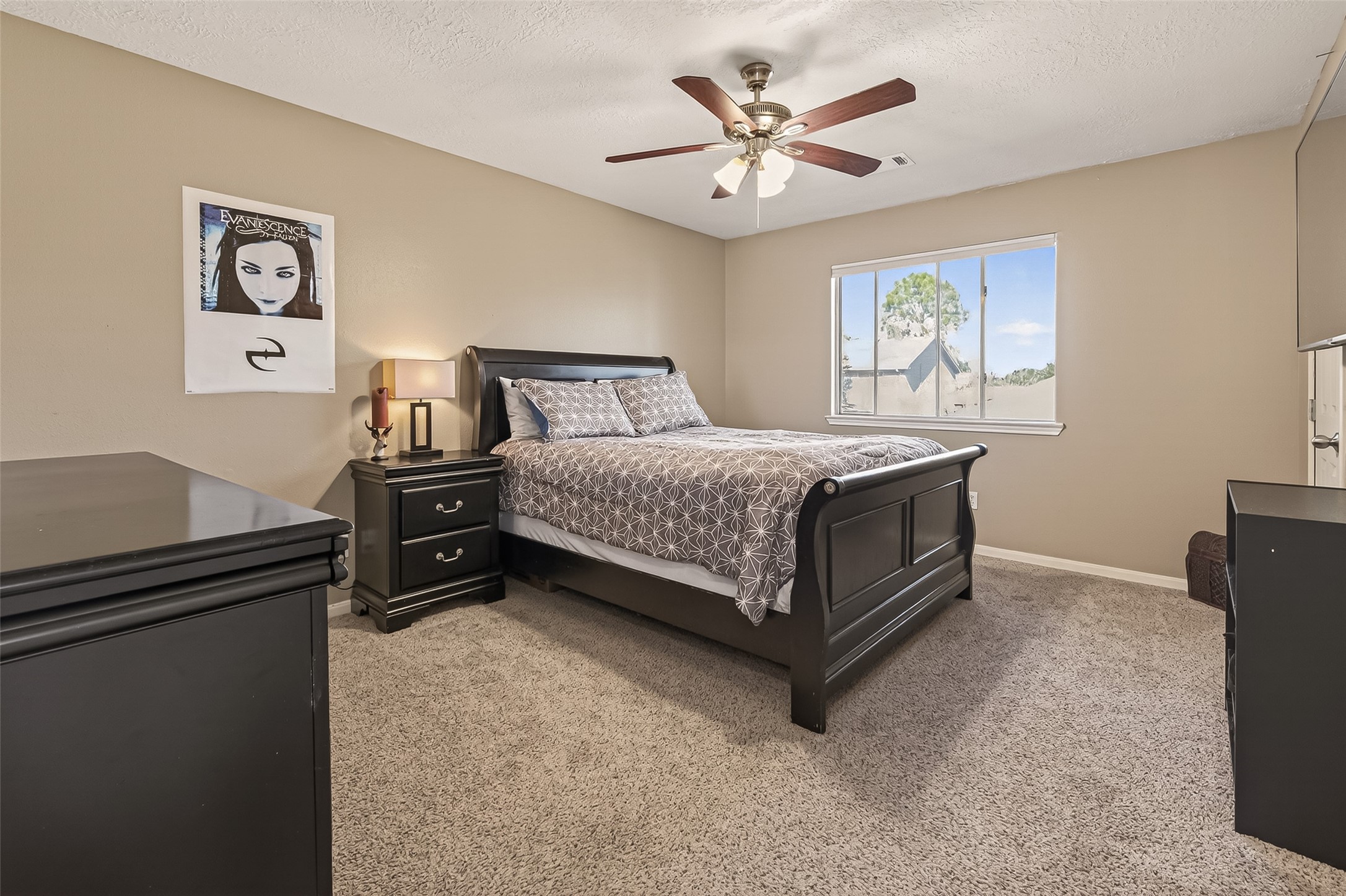 7315 Tara Blue Ridge Drive Richmond, TX 77469 - Photo 30 of 45 a bedroom with a bed and a chandelier