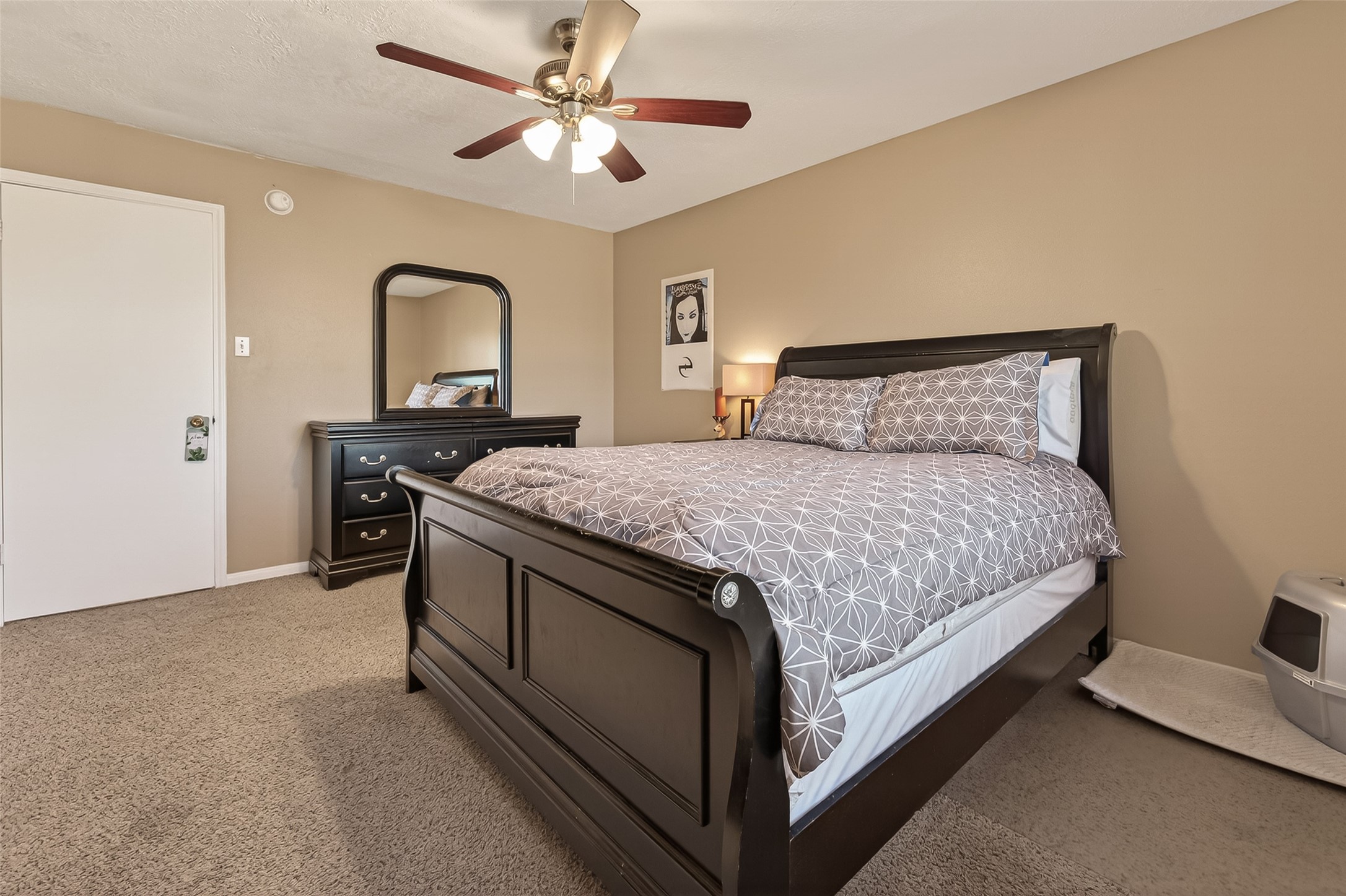 7315 Tara Blue Ridge Drive Richmond, TX 77469 - Photo 31 of 45 a bedroom with a bed and a chandelier