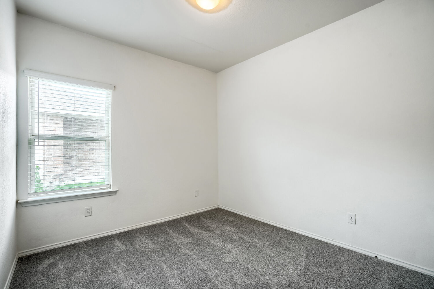 2420 Ranger Pass Seguin, TX 78155 - Photo 18 of 28 Bright room featuring a window with blinds, white walls, and gray carpet flooring