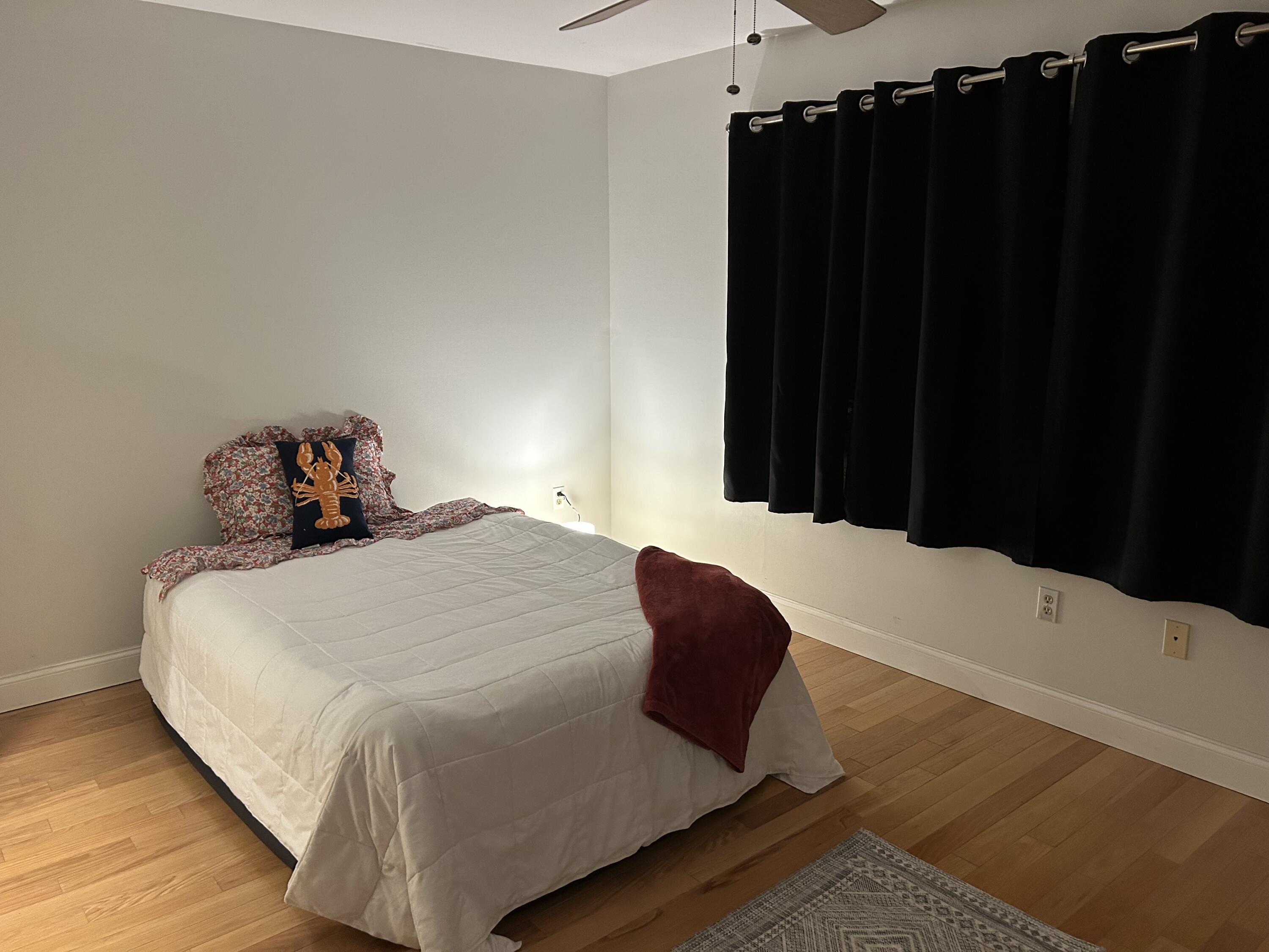 48 Camp Street, Unit 9 Hyannis, MA 02601 - Photo 15 of 42 a bedroom with a bed and wooden floor