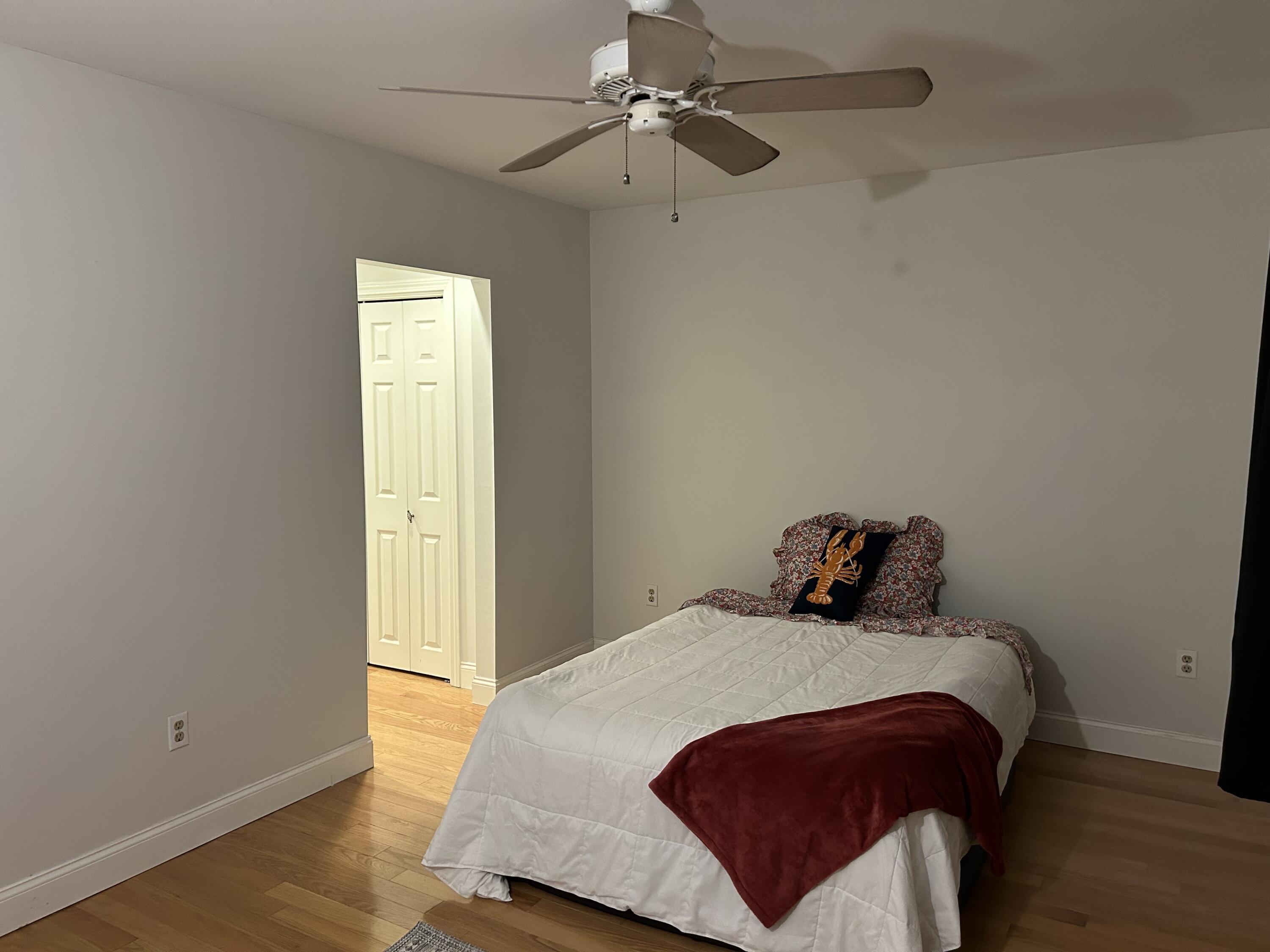 48 Camp Street, Unit 9 Hyannis, MA 02601 - Photo 18 of 42 a bedroom with a bed and wooden floor