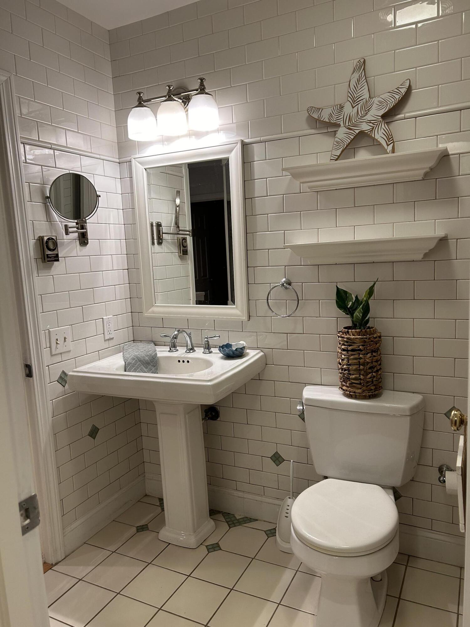 48 Camp Street, Unit 9 Hyannis, MA 02601 - Photo 22 of 42 a bathroom with a toilet sink and mirror