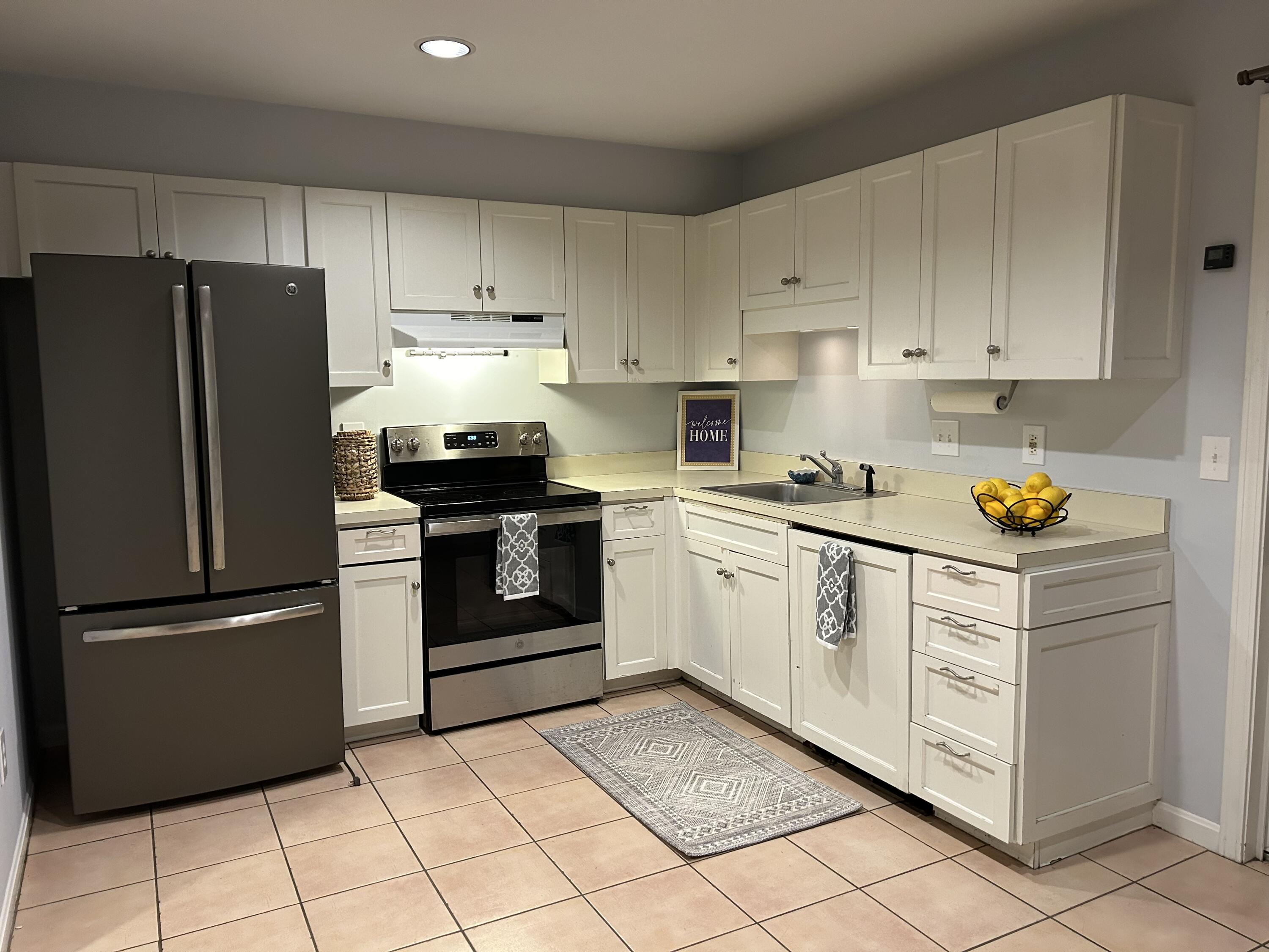 48 Camp Street, Unit 9 Hyannis, MA 02601 - Photo 7 of 42 a kitchen with white cabinets and appliances