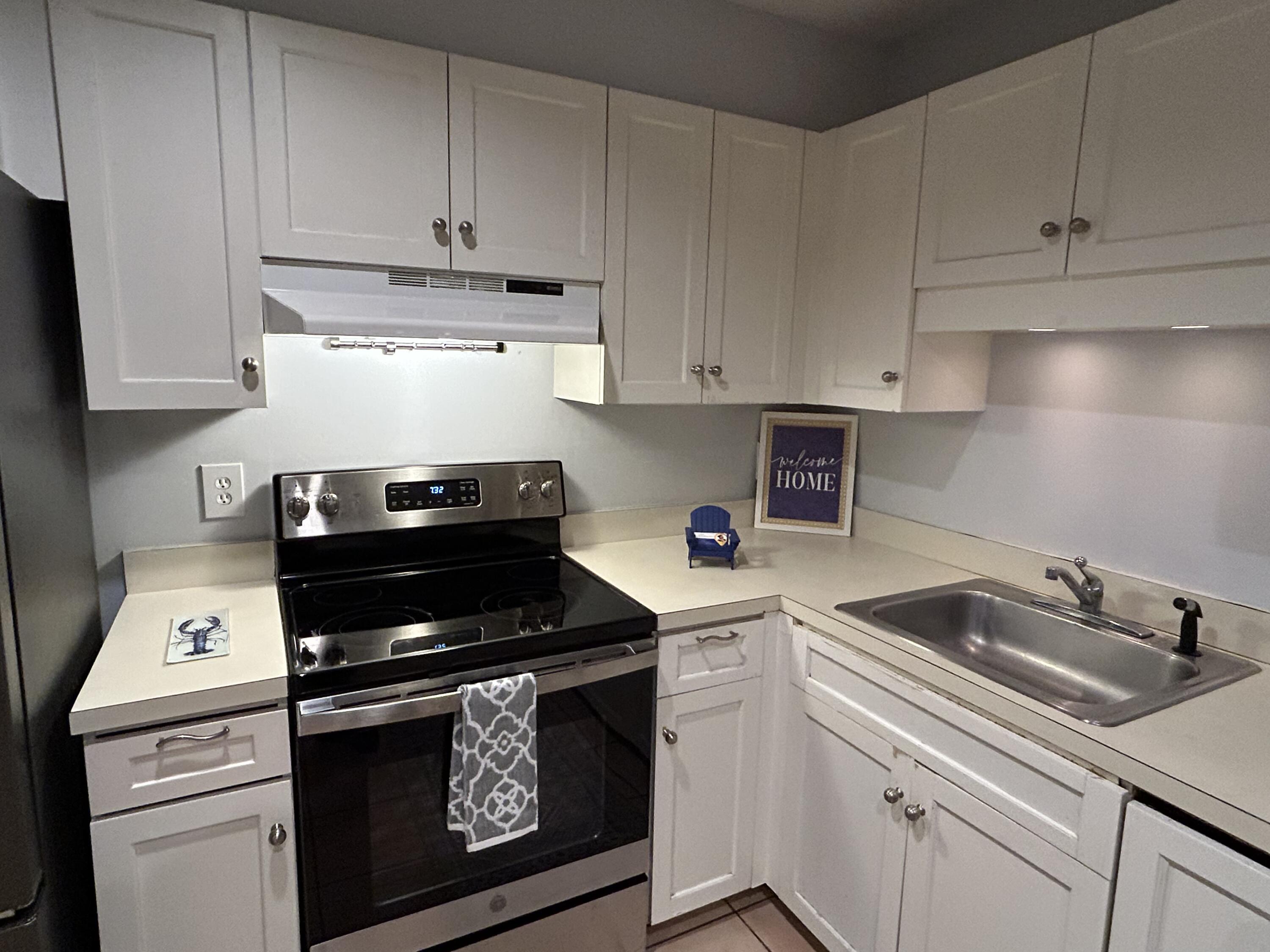 48 Camp Street, Unit 9 Hyannis, MA 02601 - Photo 8 of 42 a kitchen with a sink and cabinets