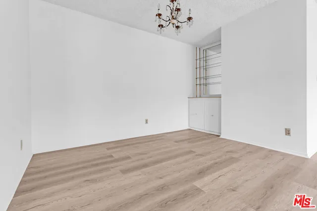 a view of empty room with a ceiling fan and wooden floor