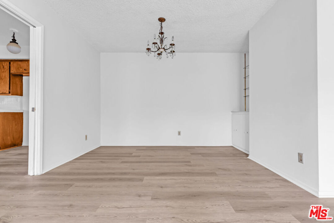 732 Lorraine Boulevard, Unit 5 Los Angeles, CA 90005 - Photo 20 of 25 a view of a chandelier in big room with wooden floor