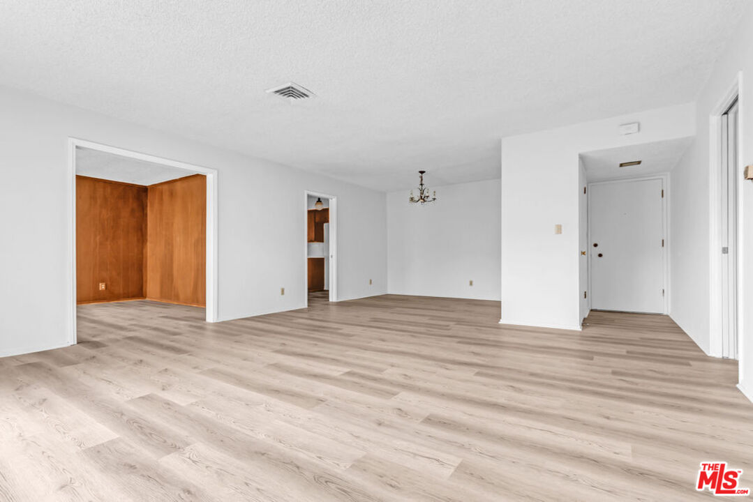 732 Lorraine Boulevard, Unit 5 Los Angeles, CA 90005 - Photo 3 of 25 a view of an empty room with wooden floor and closet