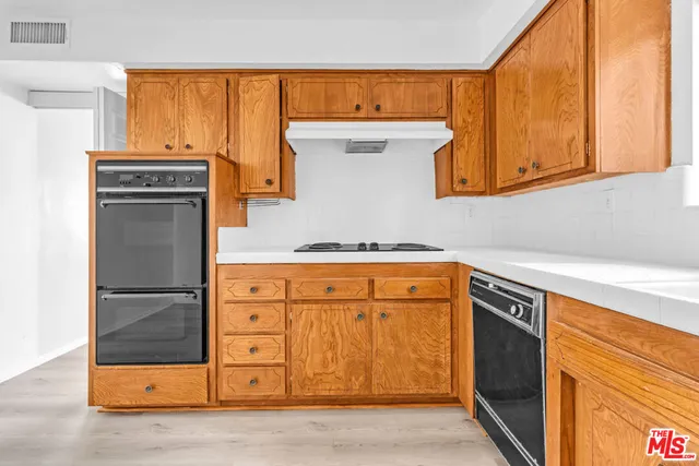 a view of a kitchen with a sink and cabinets
