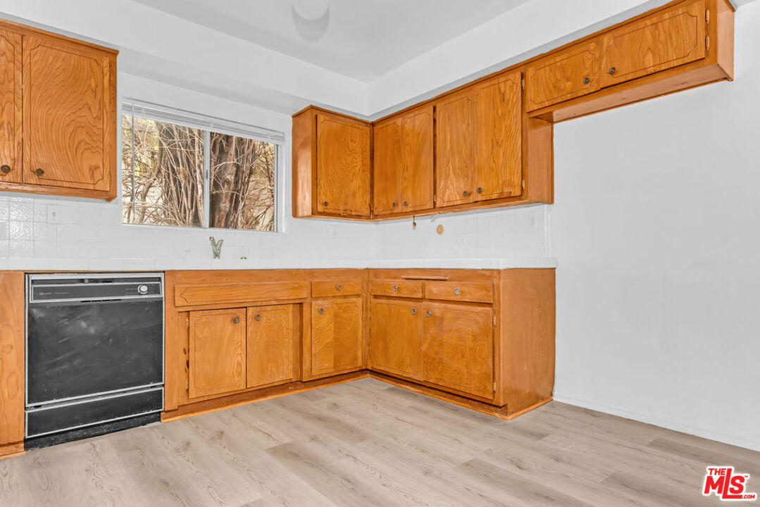 732 Lorraine Boulevard, Unit 5 Los Angeles, CA 90005 - Photo 7 of 25 a view of a kitchen with wooden floor and cabinet