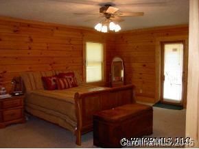 306 Dark Corner Road Rutherfordton, NC 28139 - Photo 9 of 9 a bedroom with a bed and a chandelier