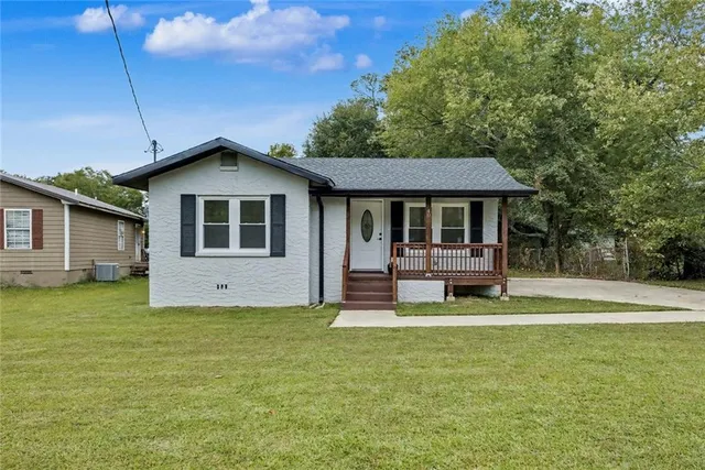 a front view of a house with a yard table and chairs