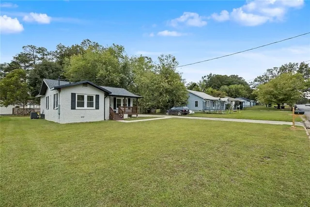 a front view of a house with garden
