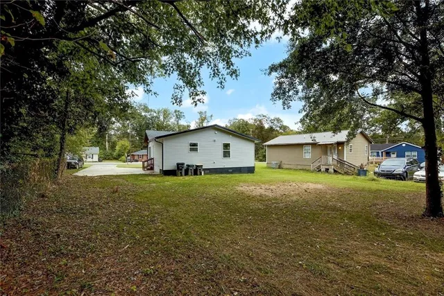 a view of a backyard with large trees