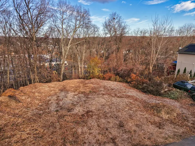 an aerial view of house with yard and mountain view in back