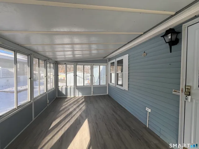 a view of hallway with wooden floor