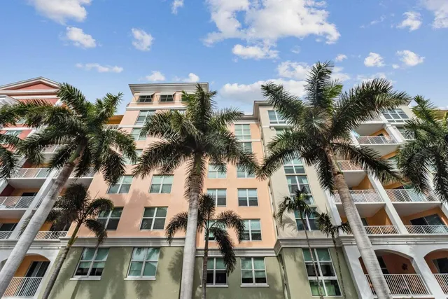 a view of a building with a palm tree