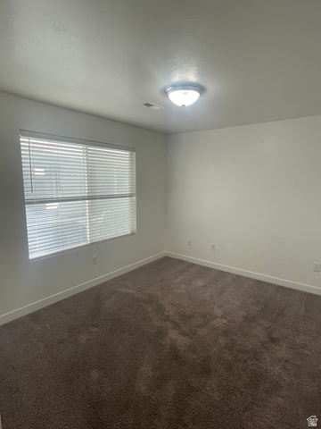 14760 Rising Star Way, Unit 71 Bluffdale, UT 84065 - Photo 24 of 41 Neutral wall finishes, textured carpeting, contemporary ceiling light fixture, and window with horizontal blinds