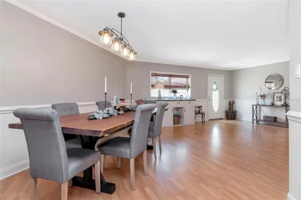 a view of a dining room with furniture wooden floor and chandelier