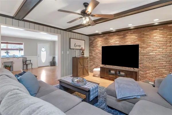 a living room with furniture and a flat screen tv